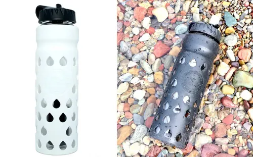 The Escape filtered water bottle in white (left) and The Escape filtered water bottle in black on a bed of pebbles (right)